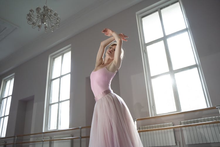 A Ballerina In Pink Tutu Dancing In The Studio