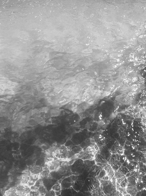 Free A monochrome image showcasing the rippling texture of ocean water. Stock Photo