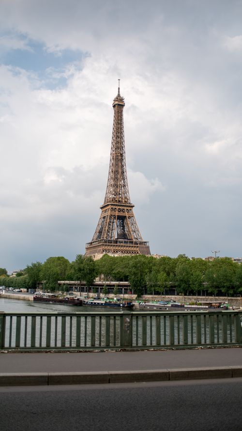 Free Scenic view of the Eiffel Tower in Paris with the Seine River, shot on a cloudy day. Stock Photo