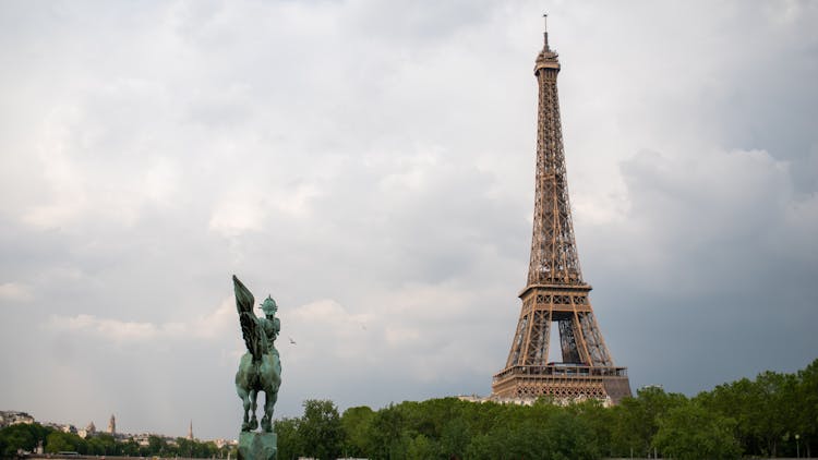 Statue Of La France Renaissante And Eiffel Tower In Paris