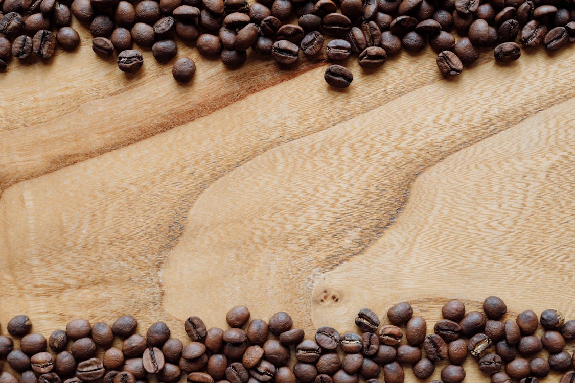 Free Black Coffee Beans on Brown Surface Stock Photo