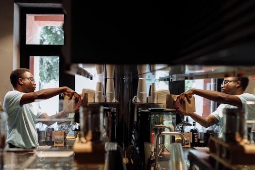 Barista working with an espresso machine in a stylish cafe environment.