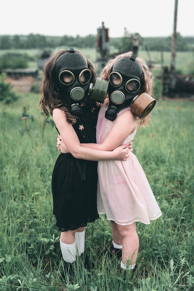 Kids In Gas Mask Hugging Each Other