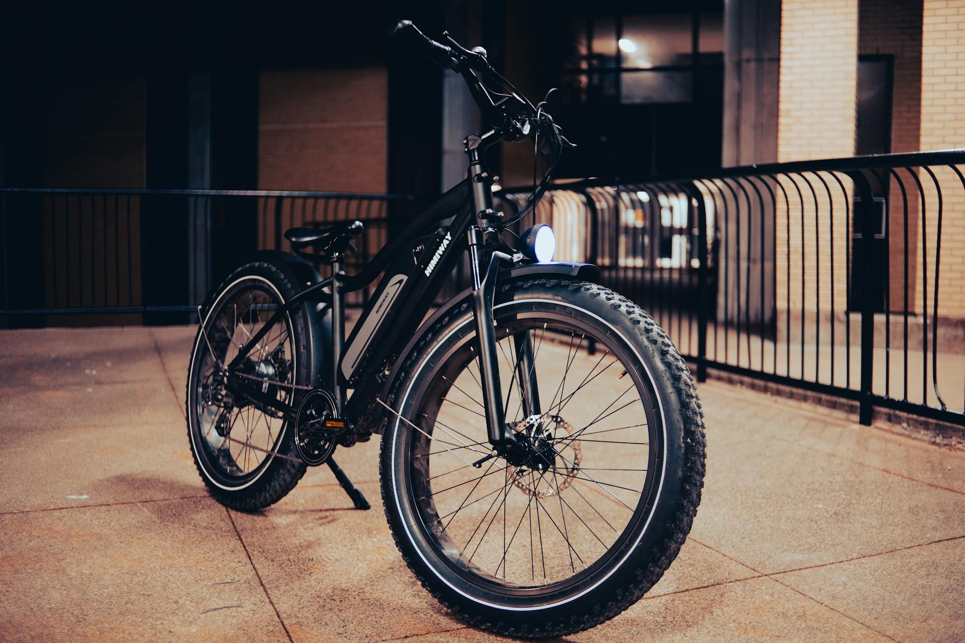 Sleek electric bike parked on a city pavement at night, showcasing urban lifestyle.