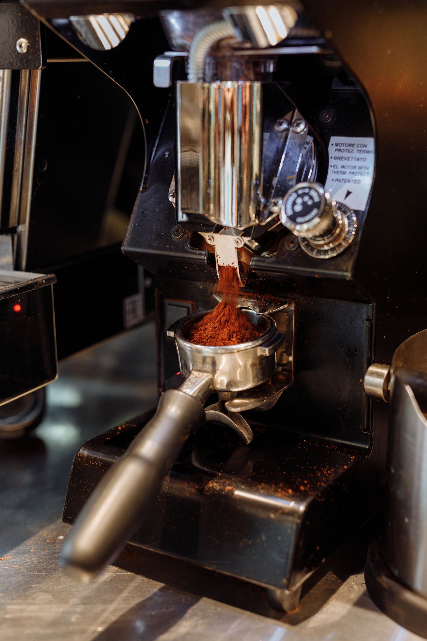 Freshly ground coffee being prepared in an espresso portafilter