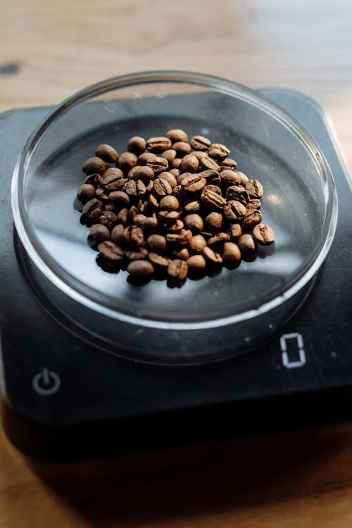 Coffee Beans on Clear Glass Container On A Weighing Scale