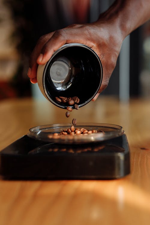 Free A Person Weighing Coffee Beans Stock Photo