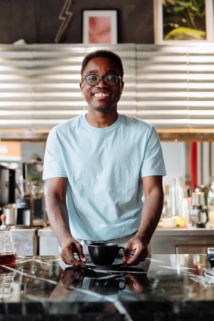 Man Serving A Cup Of Coffee