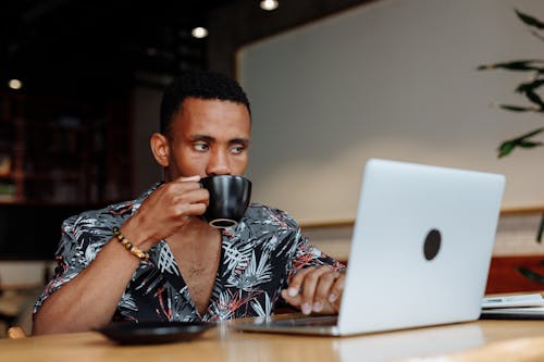 Free A Man Drinking Coffee While Working  Stock Photo