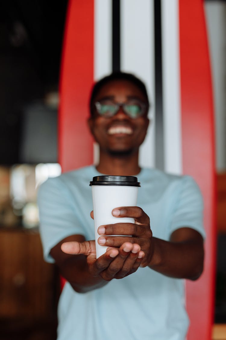Man Holding Coffee And Smiling