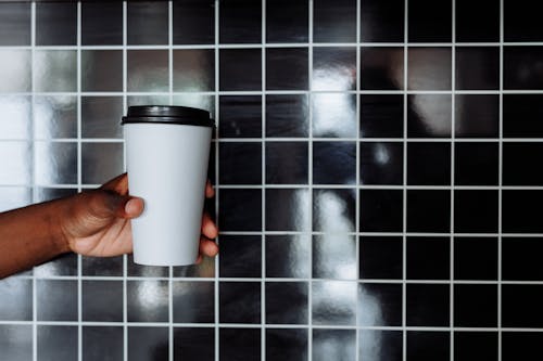 Person Holding a Disposable Cup