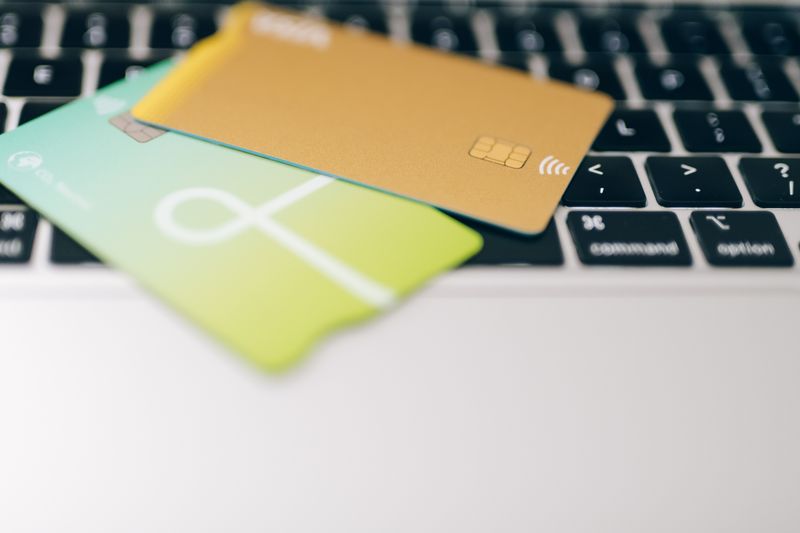 Two credit cards placed on a laptop keyboard highlighting online payment concept.