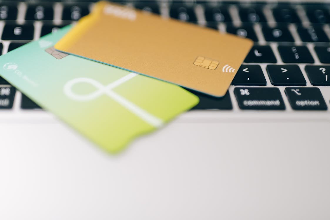 Free Close-Up Shot of Credit Cards on Laptop Keyboard Stock Photo