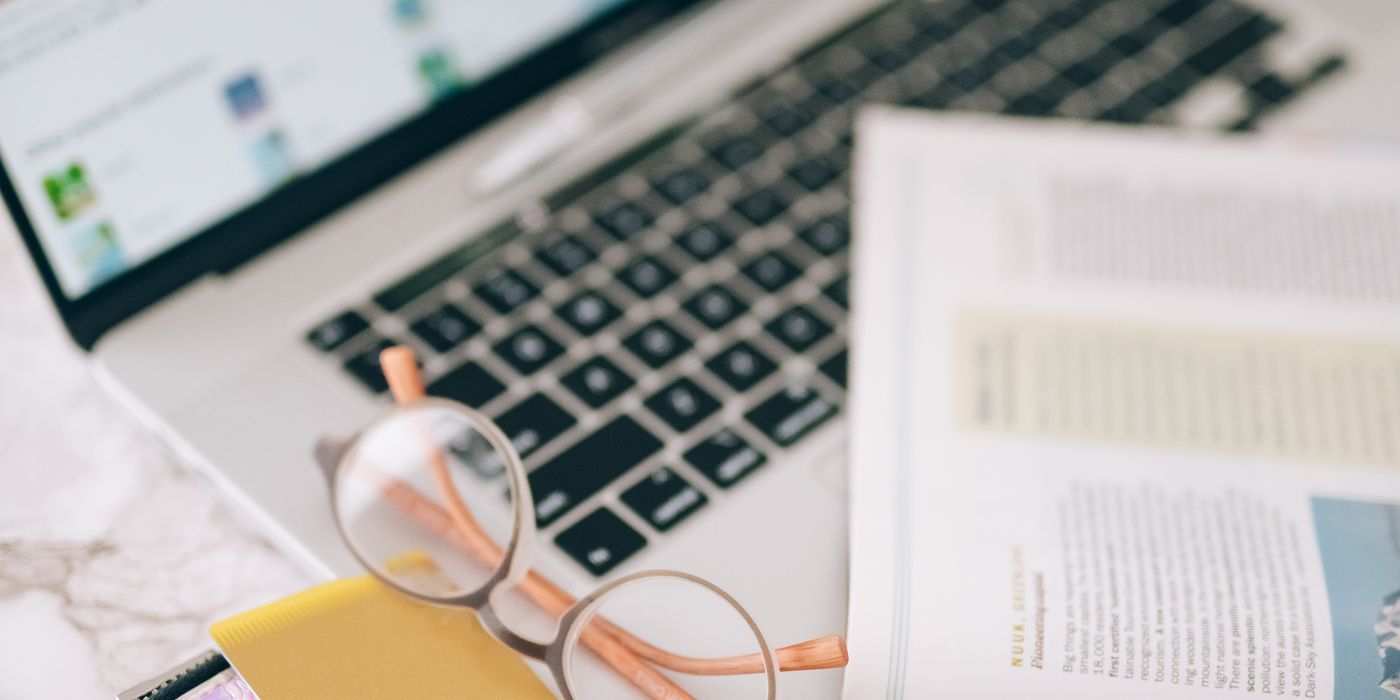 Laptop and credit card on a desk while booking a hotel room online