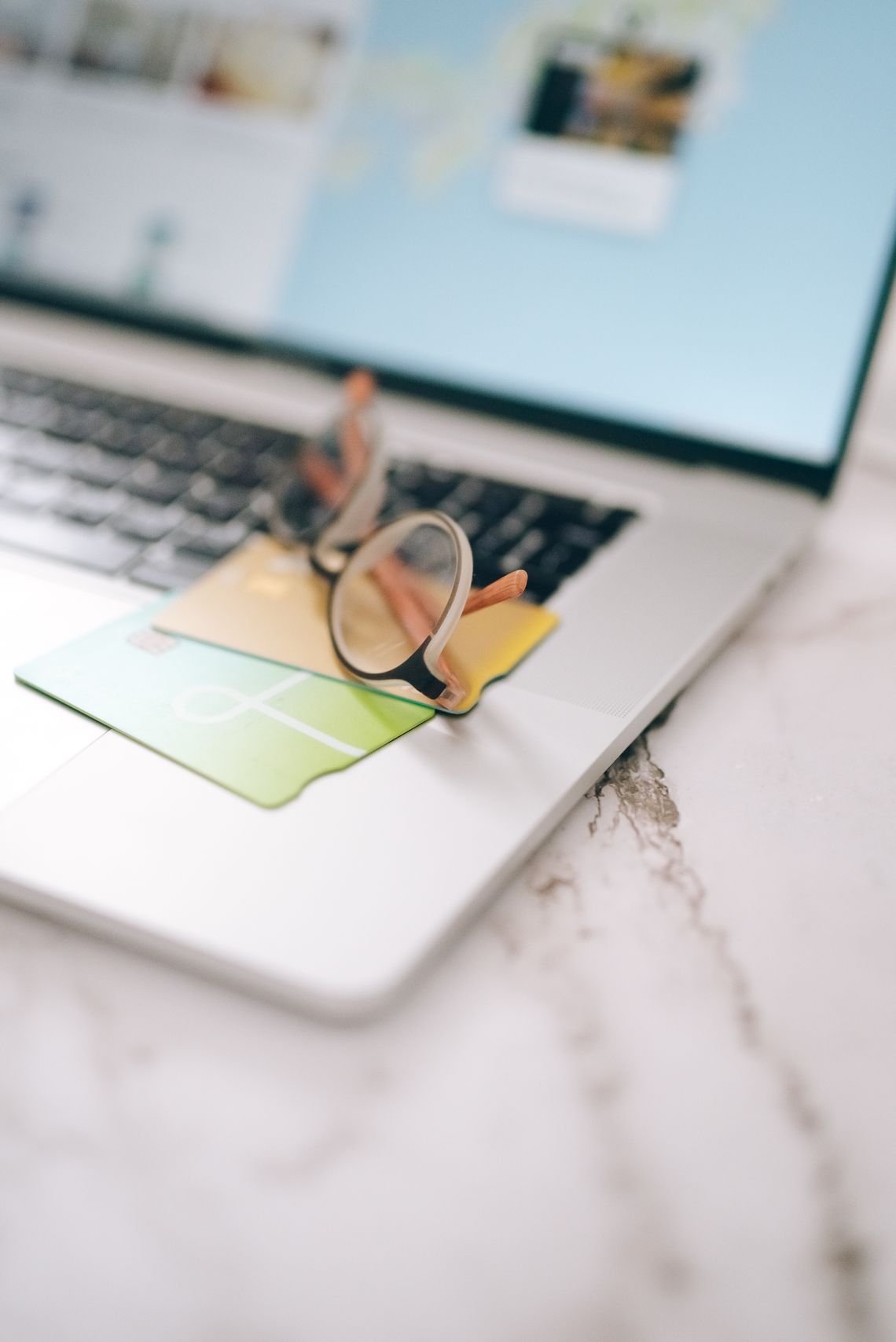 Payment cards arranged beside a laptop during online checkout