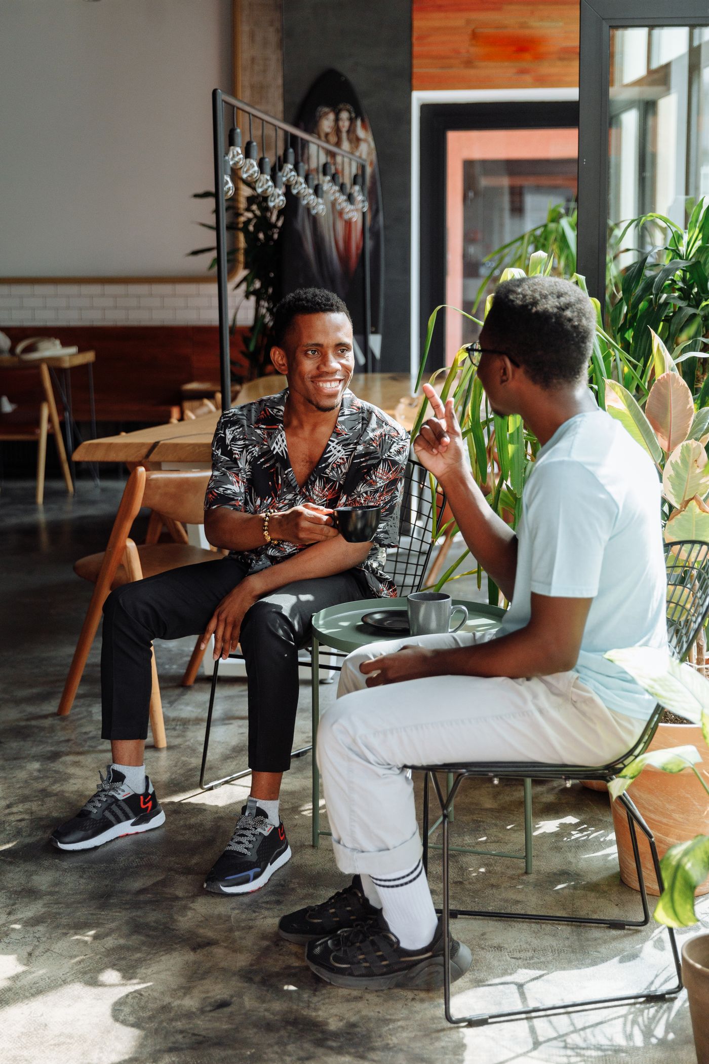 Two men talking over coffee in a café