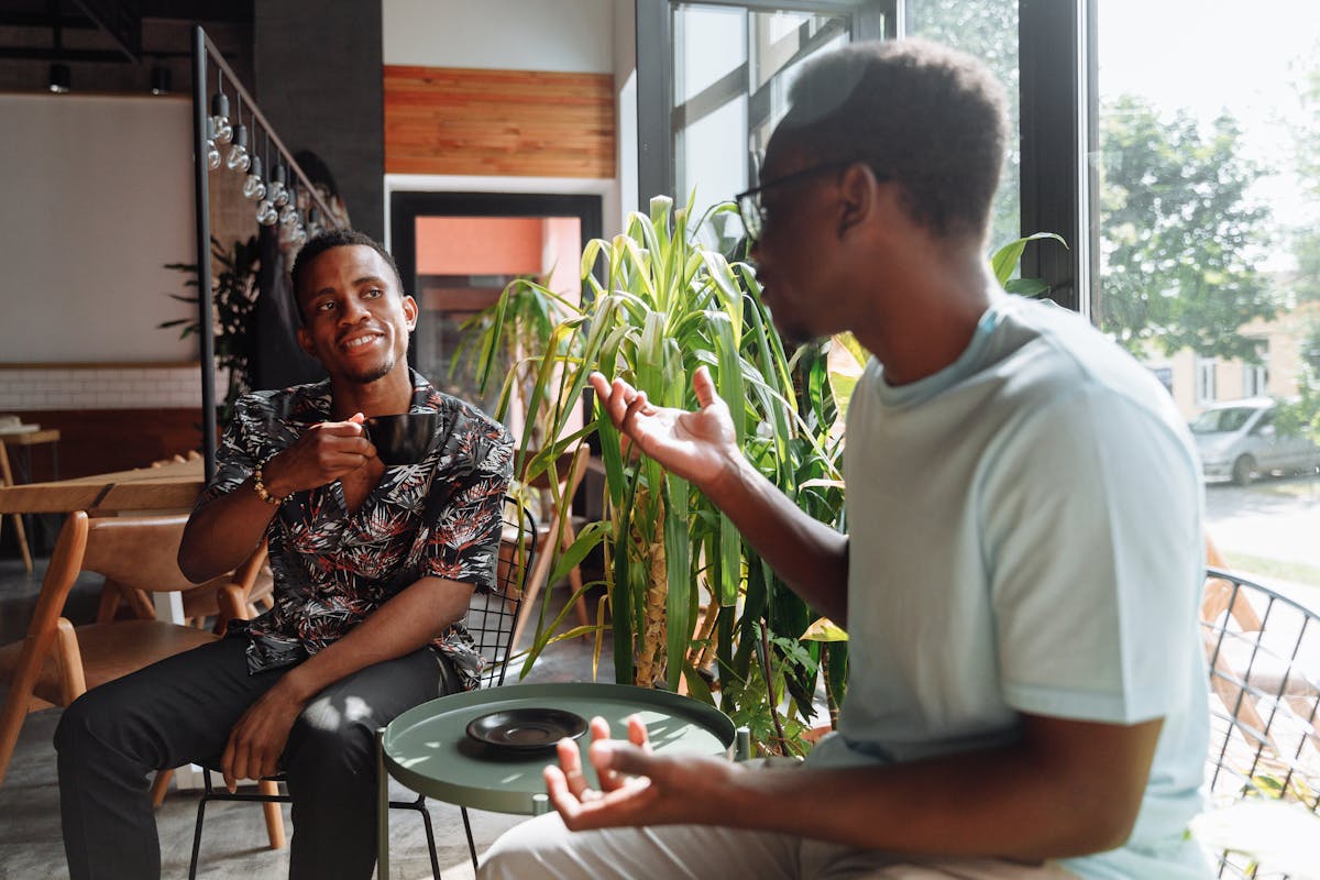 Men Having Coffee Beside a Window