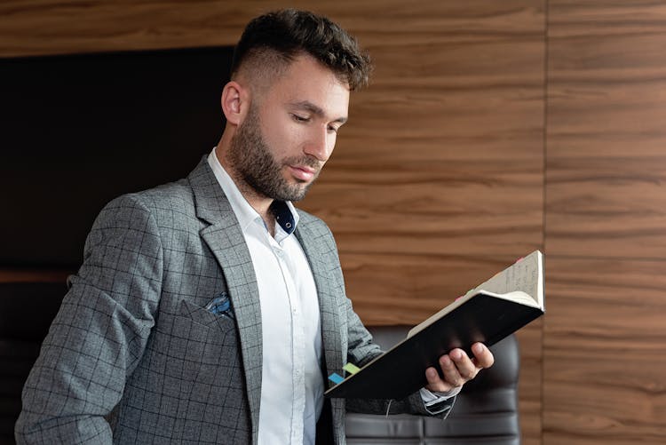 Man In Gray Blazer Reading A Book