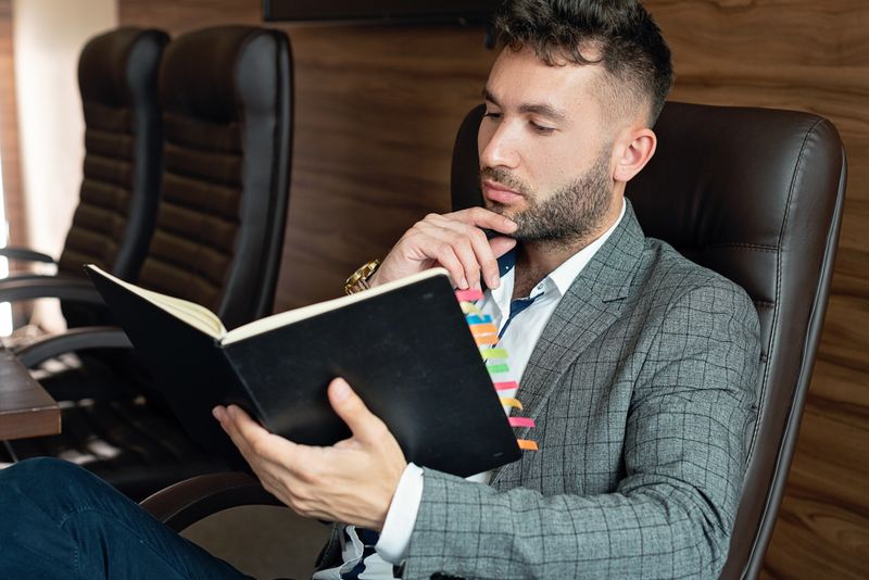 Man seated in an office chair, photo by Mikhail Nilov on Pexels