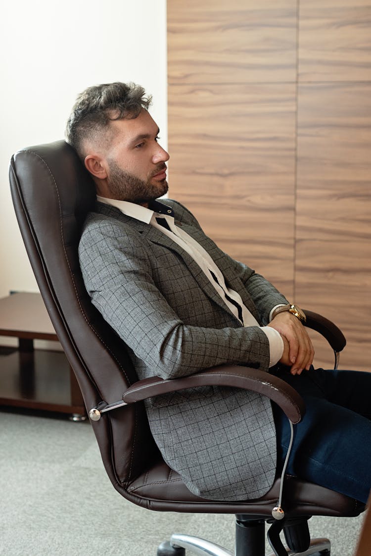 Man Sitting On A Office Chair