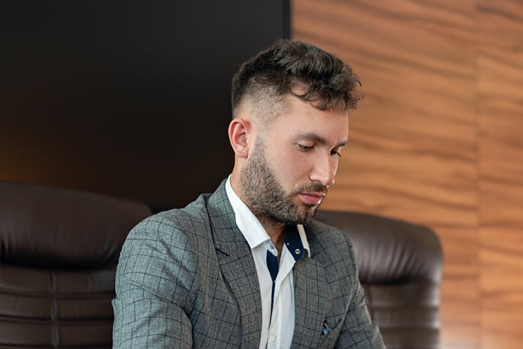 Man In Gray Blazer Looking Down