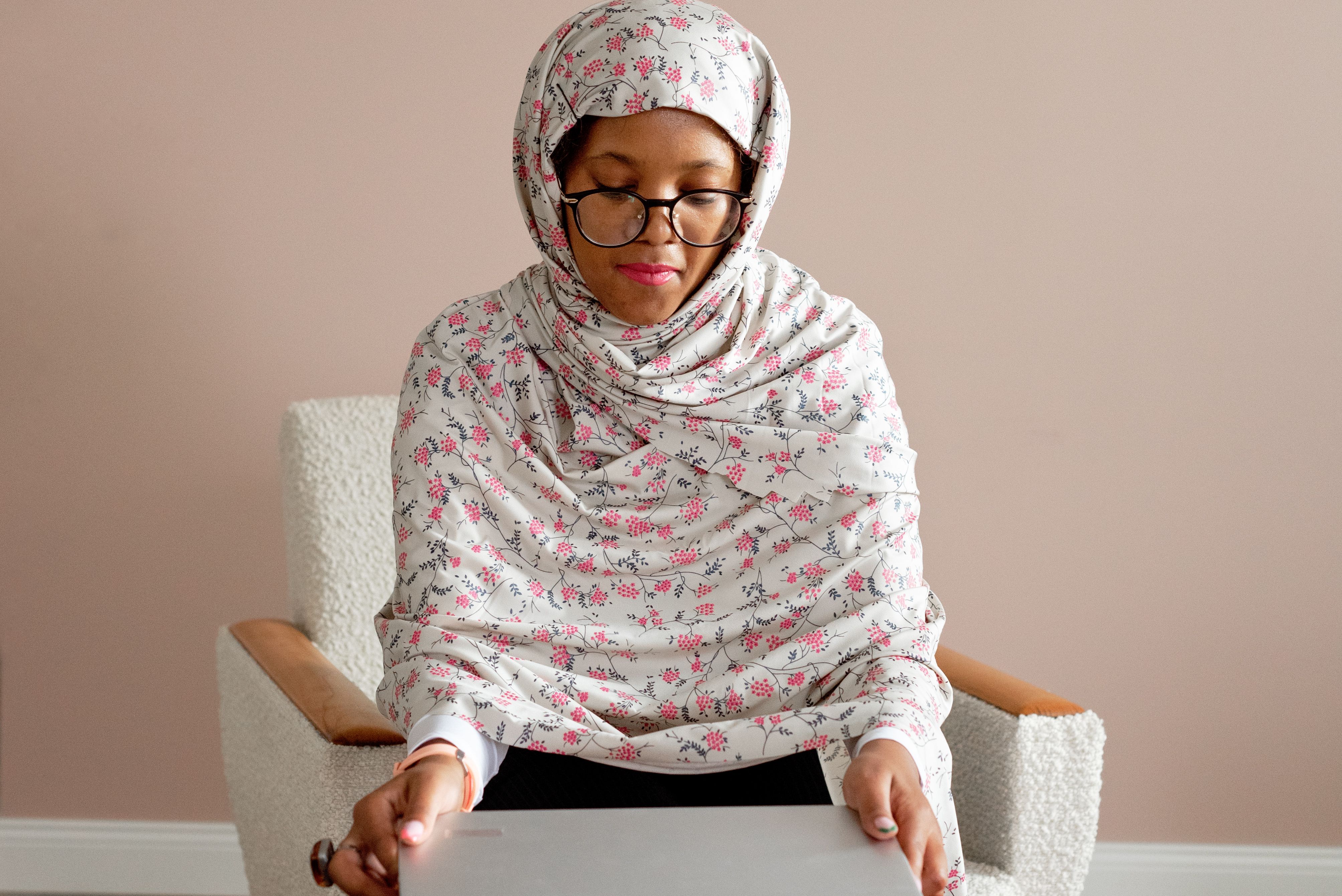 A Woman in Floral Hijab Using Her Laptop · Free Stock Photo