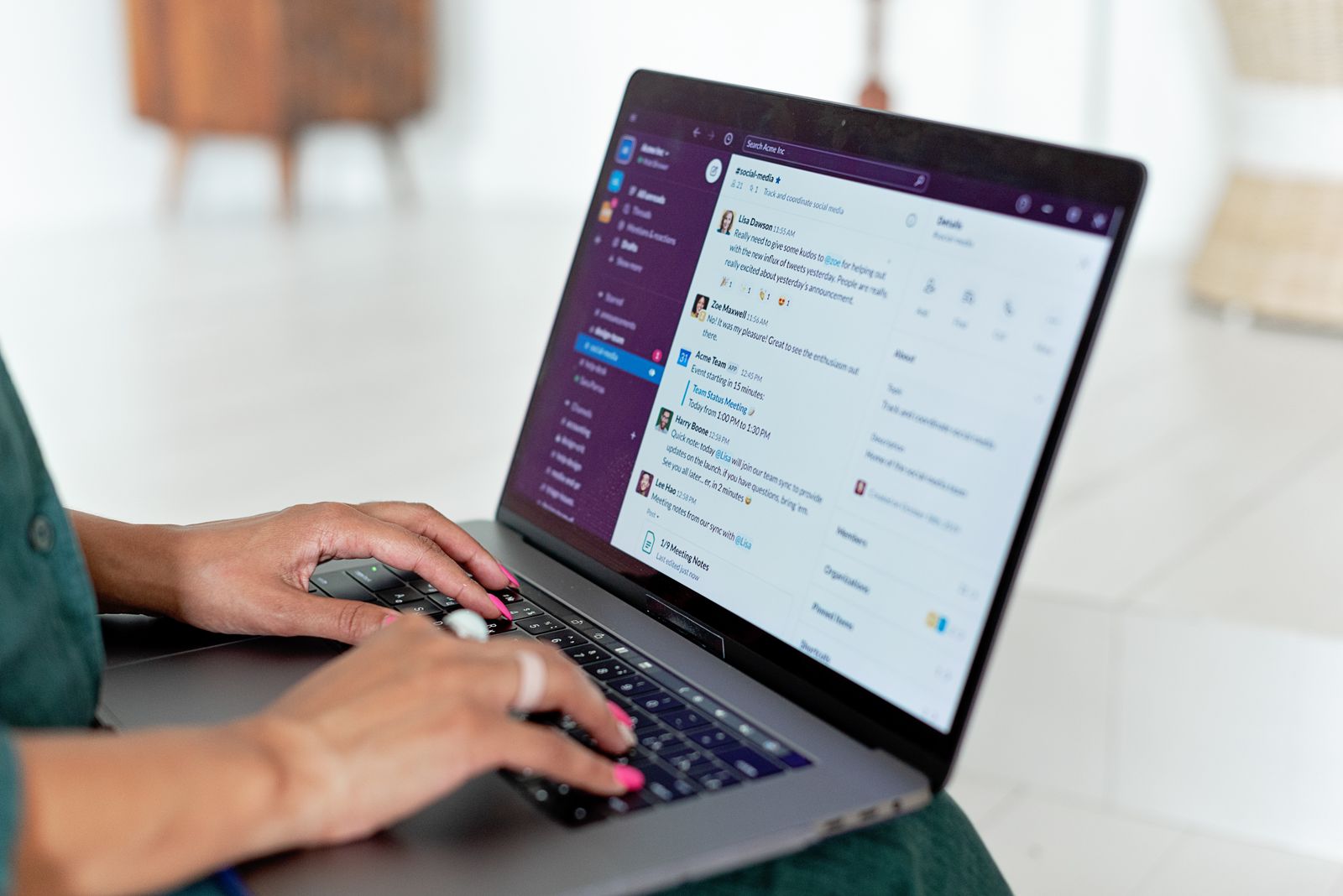 A person typing on a laptop using a messaging app