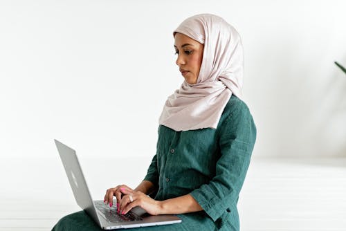 Woman Typing on a Laptop
