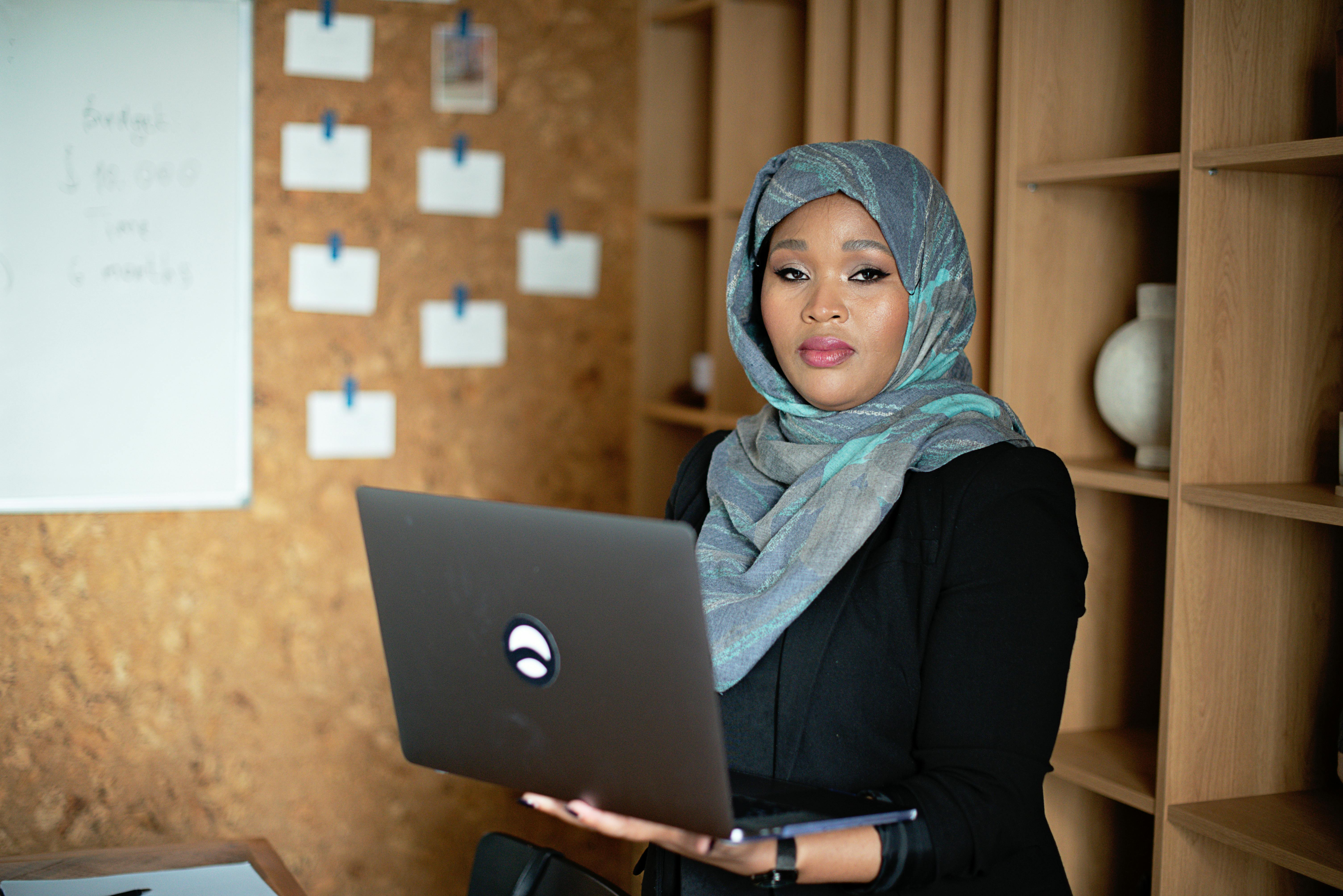 Woman in Gray Hijab Holding a Laptop