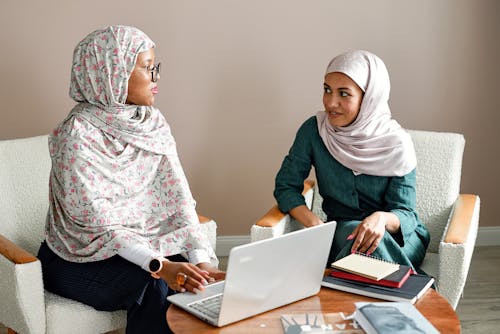 Free Women in Hijab Sitting while Having Conversation Stock Photo