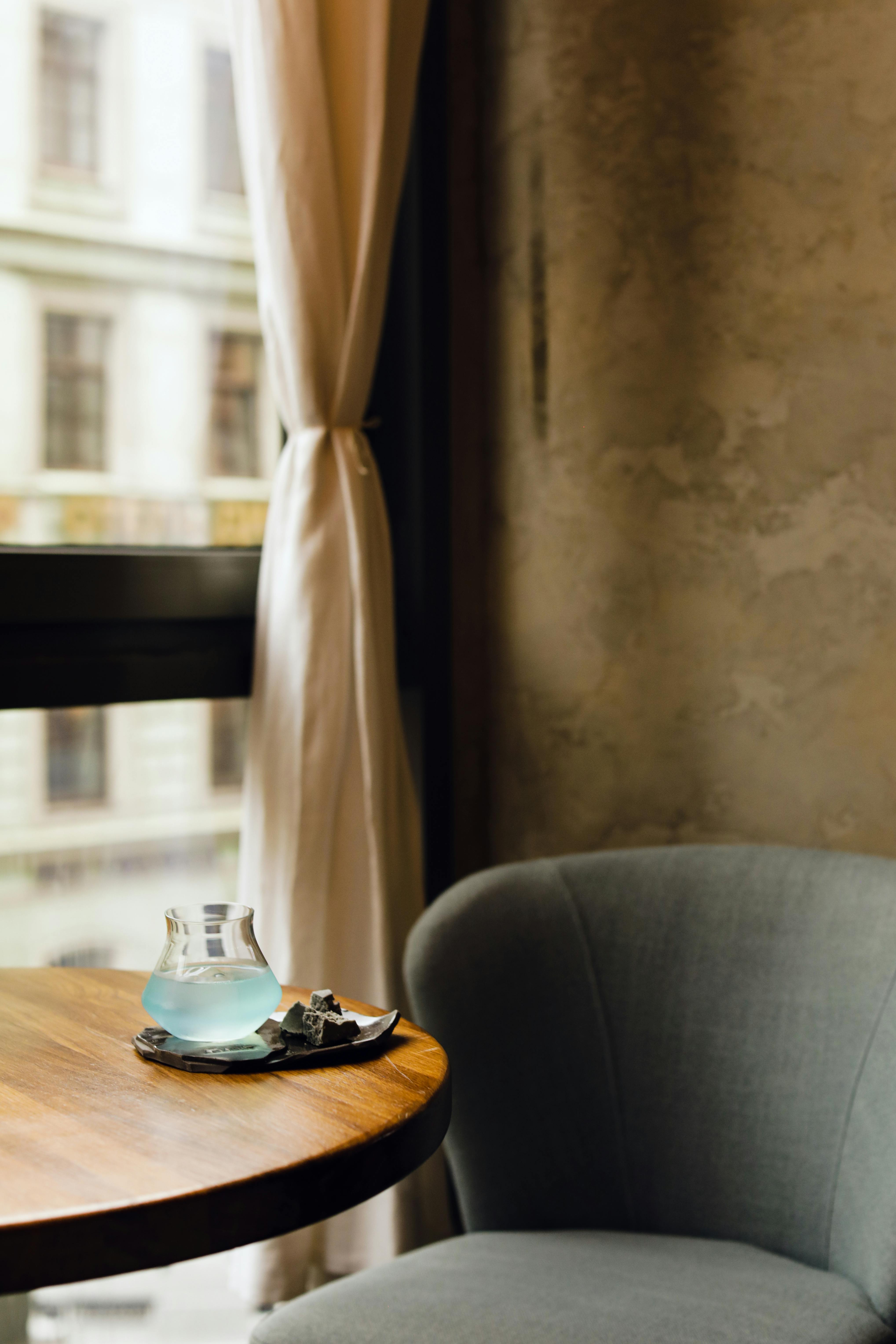 Free A peaceful interior scene featuring an armchair and window light, perfect for relaxation. Stock Photo