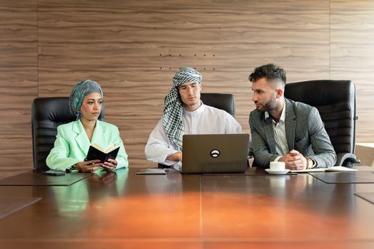 Man in Gray Suit Jacket Sitting Beside Woman in White Hijab
