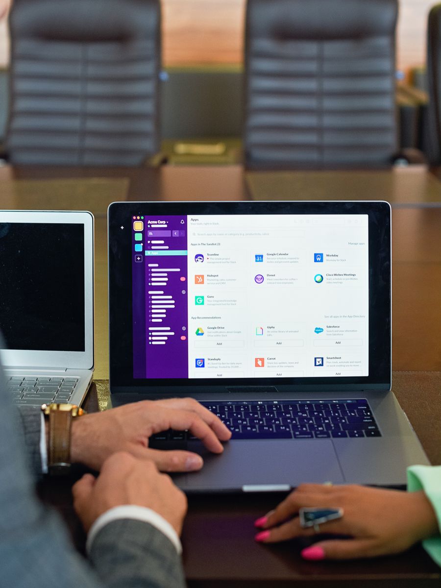 Person using a laptop at a meeting table