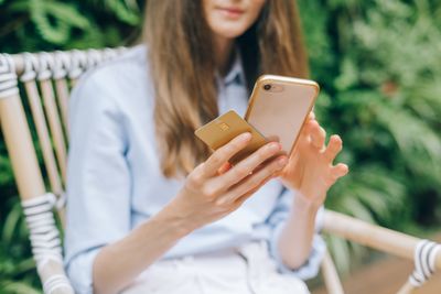Person checking a phone outdoors — photo by Leeloo The First on Pexels