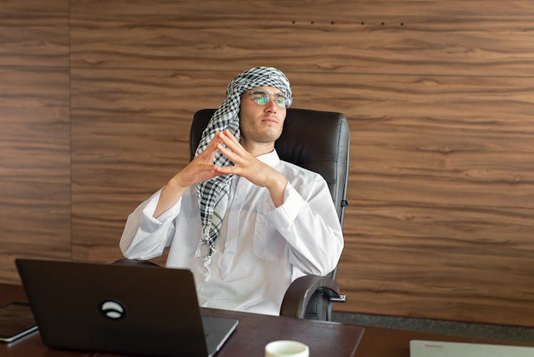 A Man Sitting On The Office Chair 