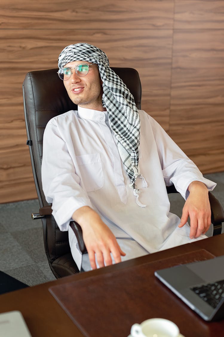 A Man Sitting On An Office Chair 