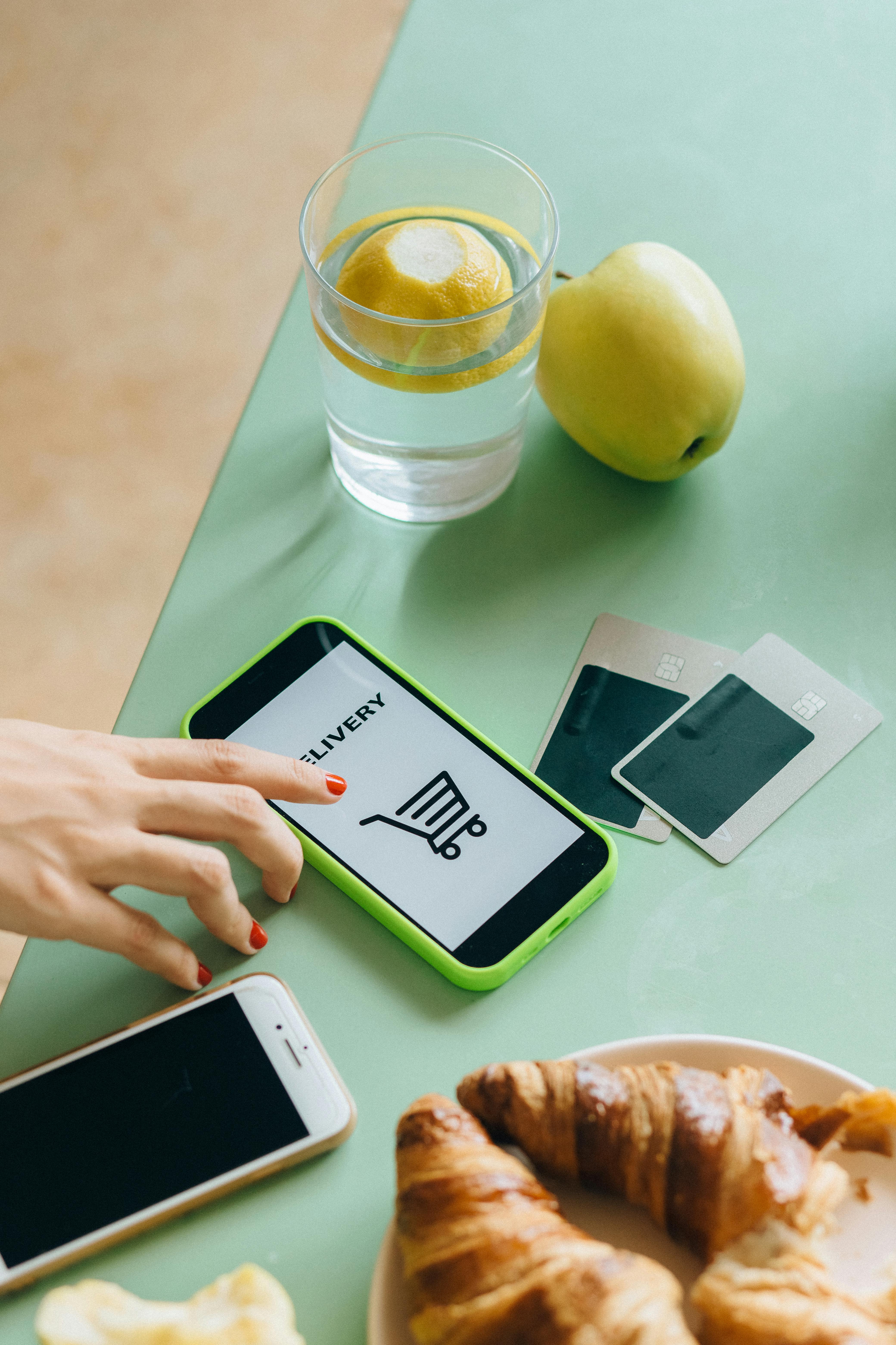 white samsung android smartphone beside green apple fruit