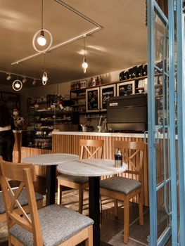 Inviting coffee shop interior featuring wooden furniture, warm lighting, and modern decor.