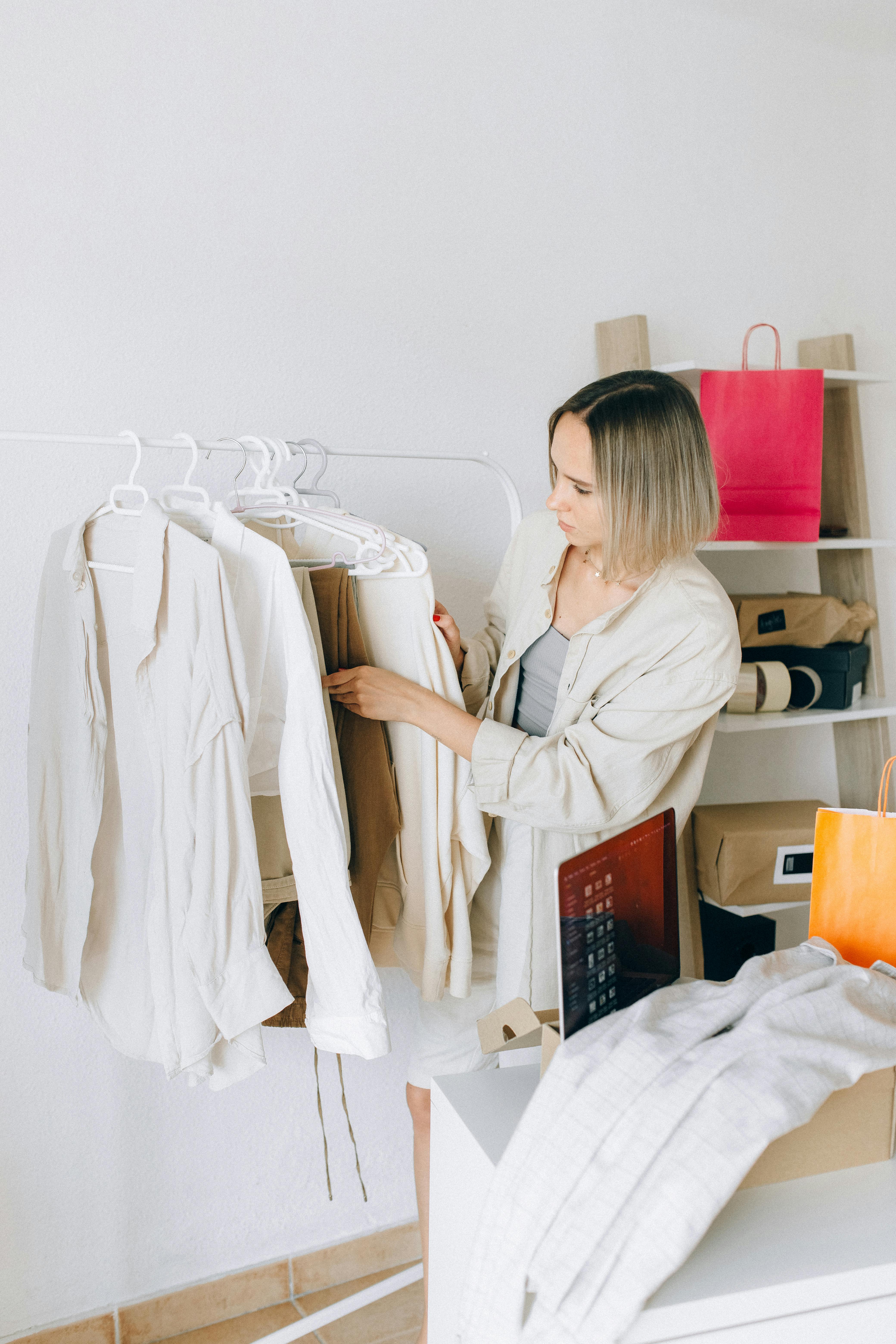 a woman choosing clothes from the rack