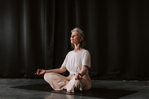Free An Elderly Woman Meditating with Aakash Mudra Hand Position Stock Photo