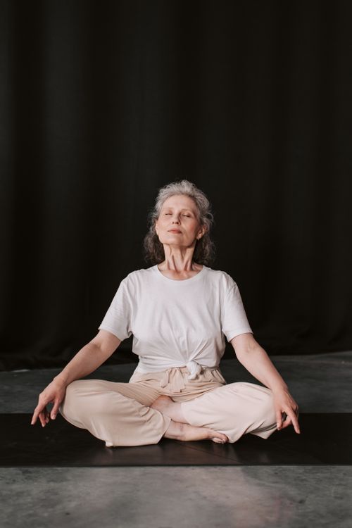 Free Elderly woman practicing meditation in a peaceful setting, sitting in lotus pose. Stock Photo