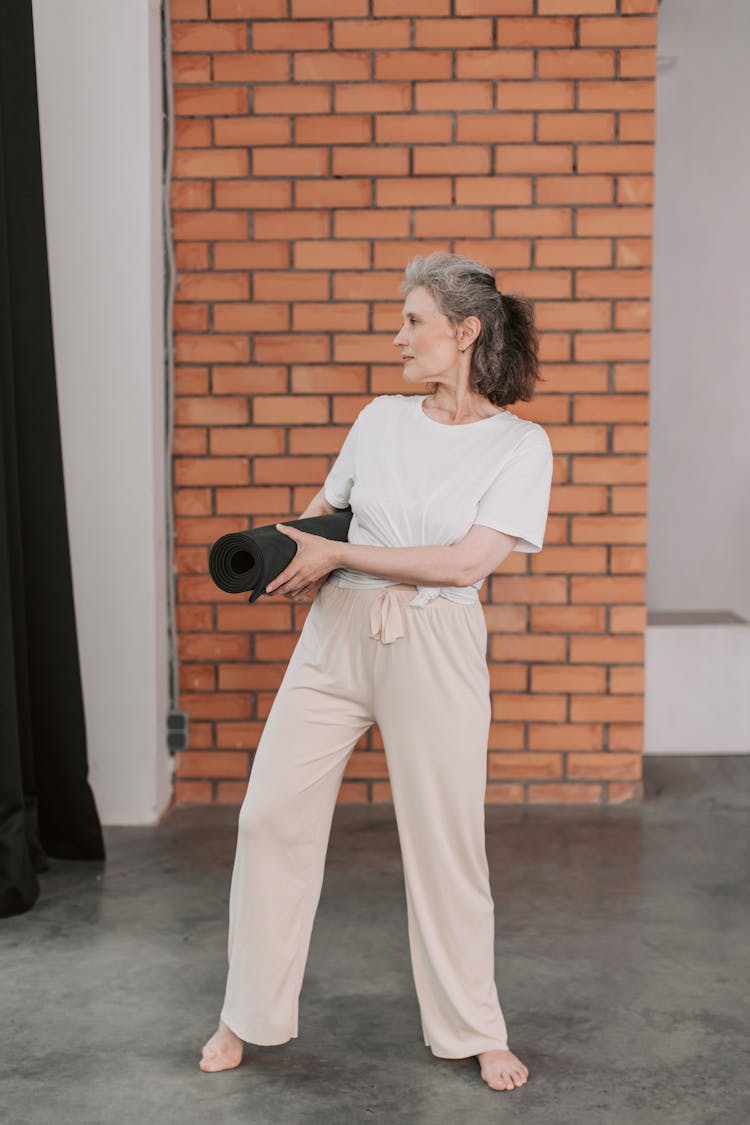 Elderly Woman Holding A Yoga Mat