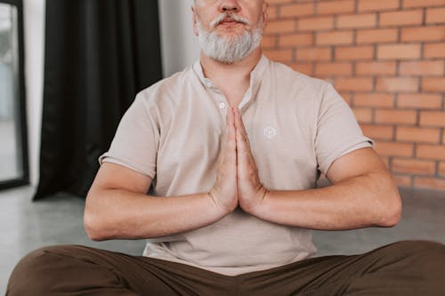 An Elderly Man in Namaste Yoga Pose