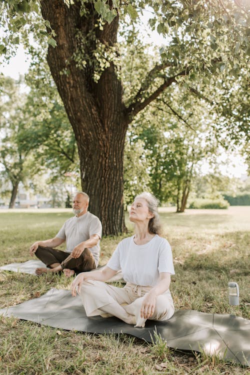 A Man and Woman Doing Yoga Together 
