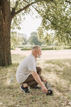 Senior man setting up yoga mat outdoors, promoting healthy lifestyle.