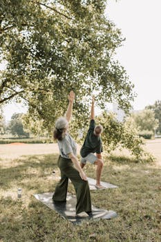 Senior adults enjoying outdoor yoga under a tree, promoting a healthy lifestyle.