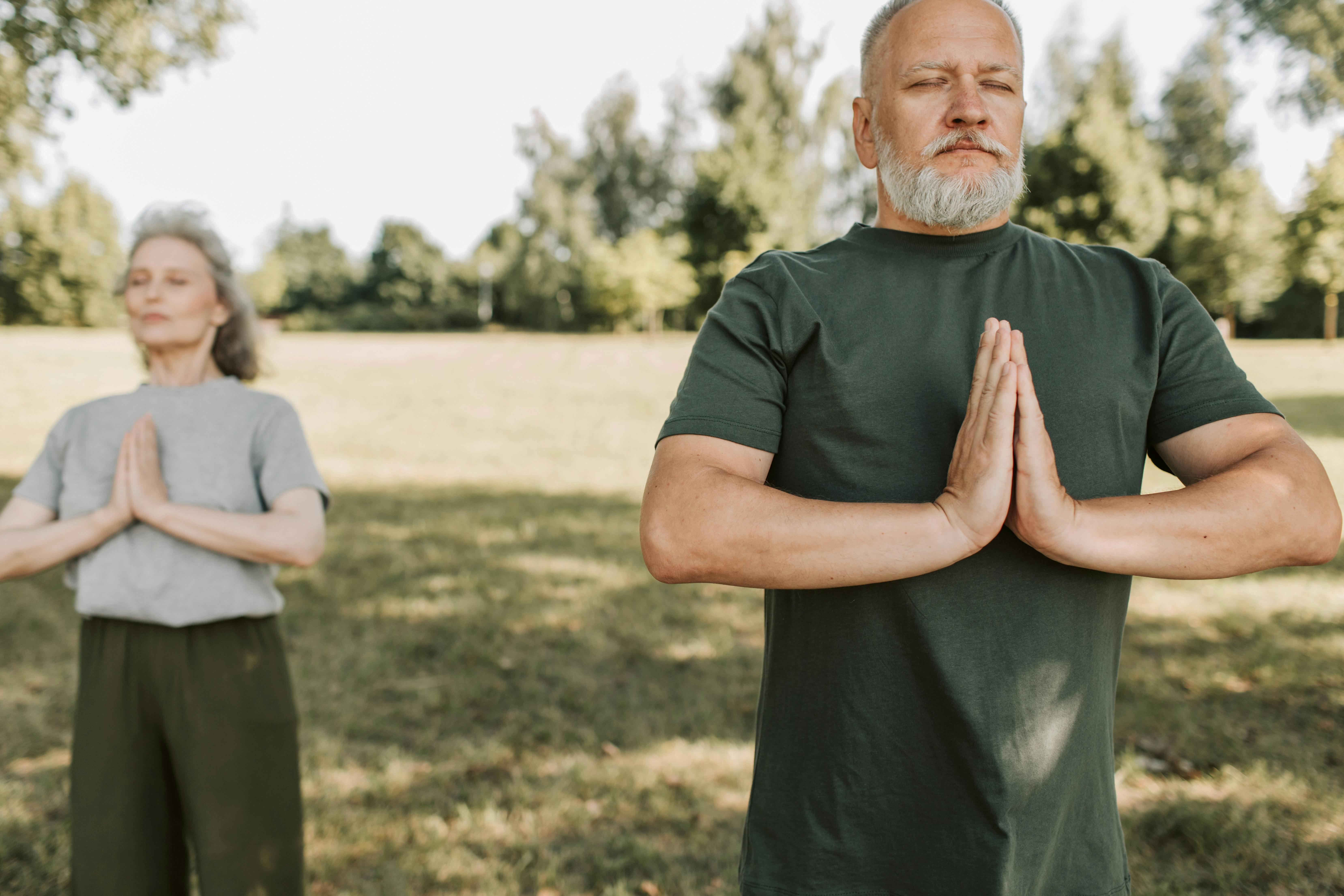 an elderly man doing yoga