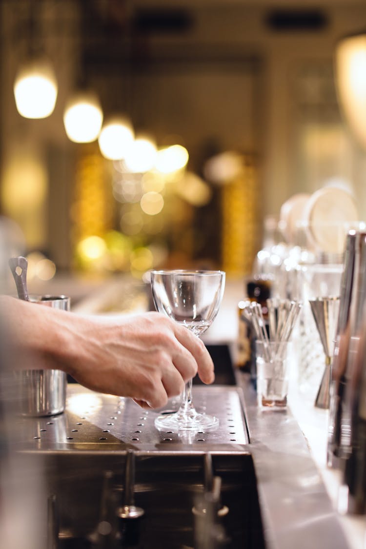 A Person's Hand Holding An Empty Glass