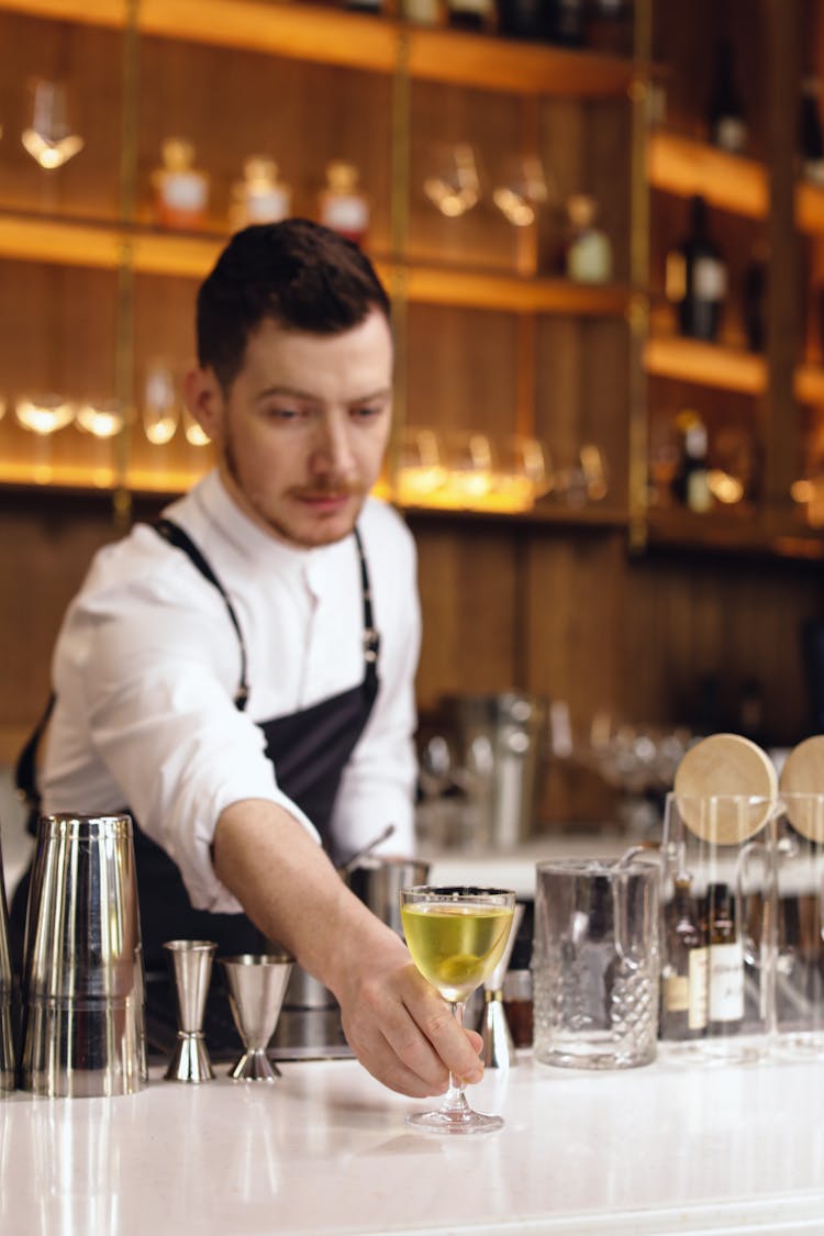 A Man Serving A Cocktail Drink