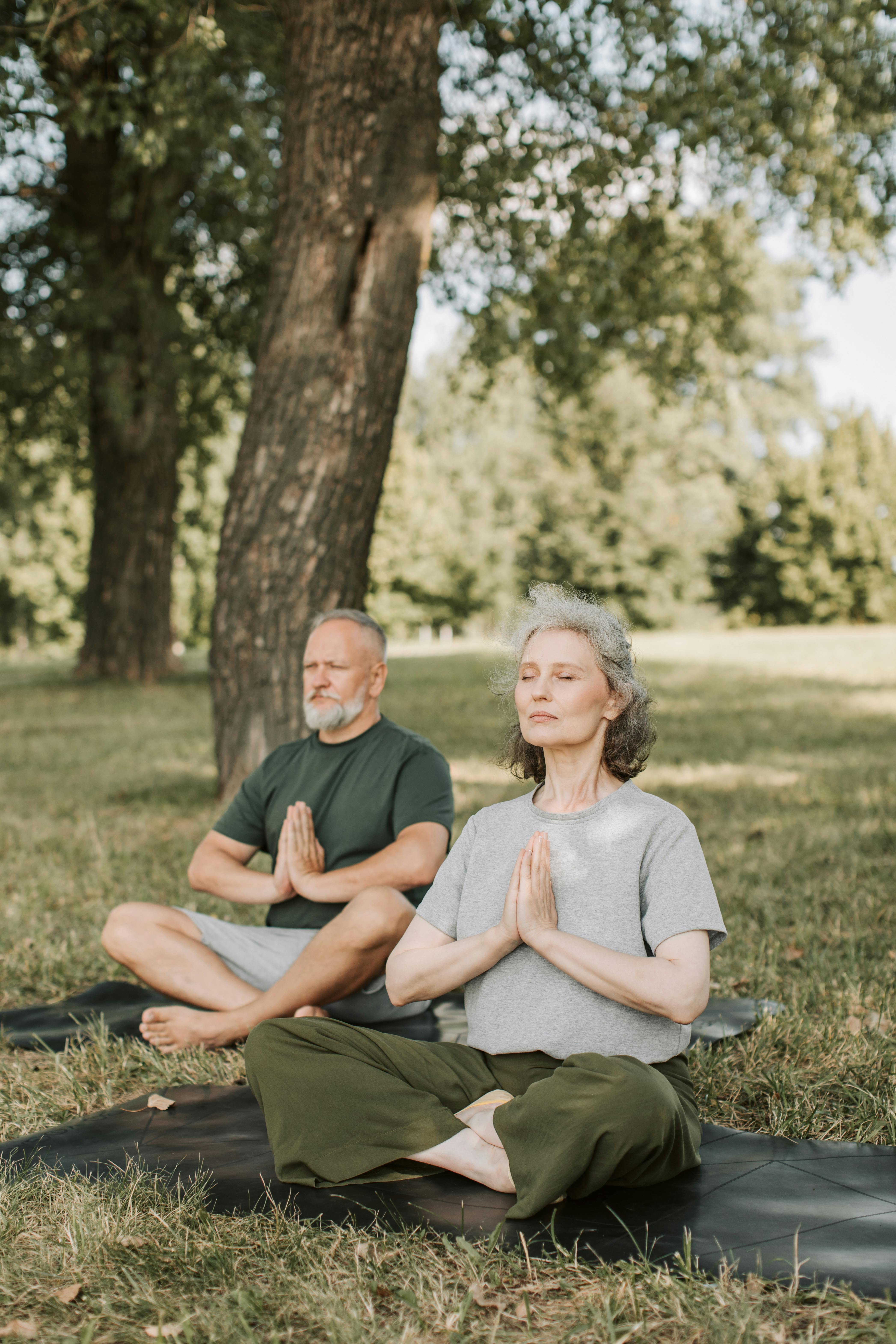 elderly couple meditating